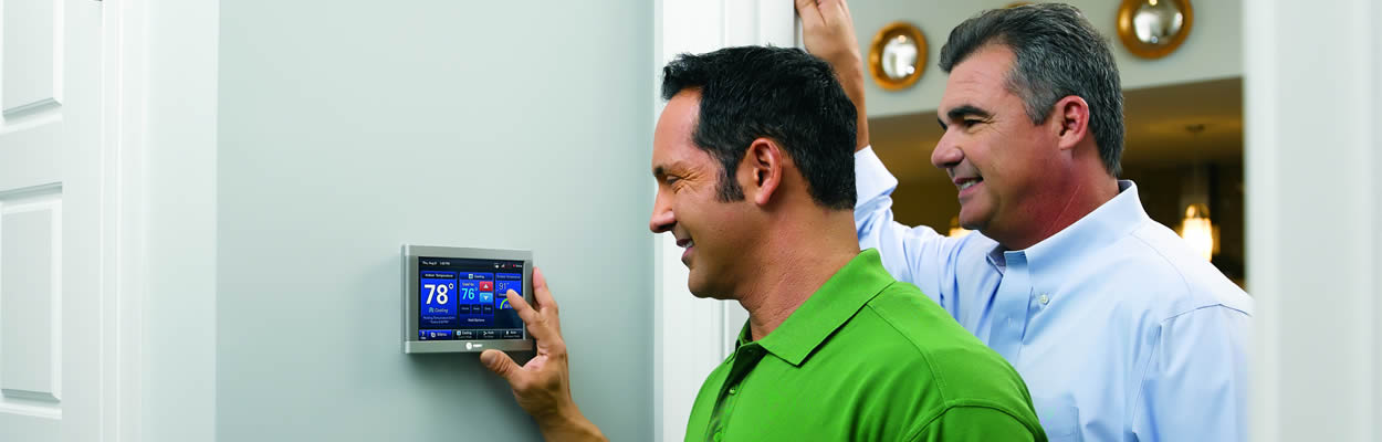 Hvac Tech Showing Customer How To Use Smart Thermostat
